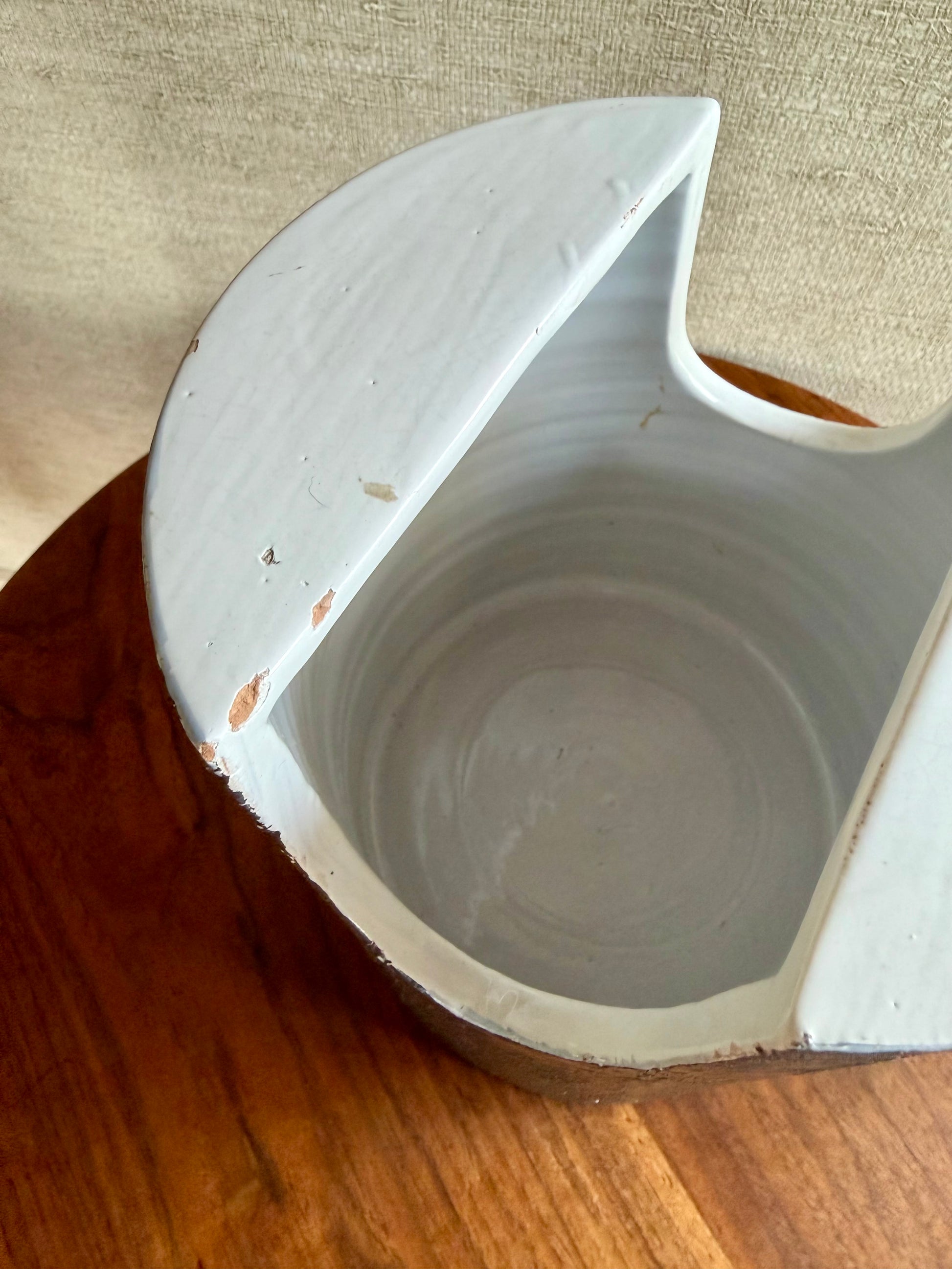 Ceramic planter with a unique design on a wooden surface