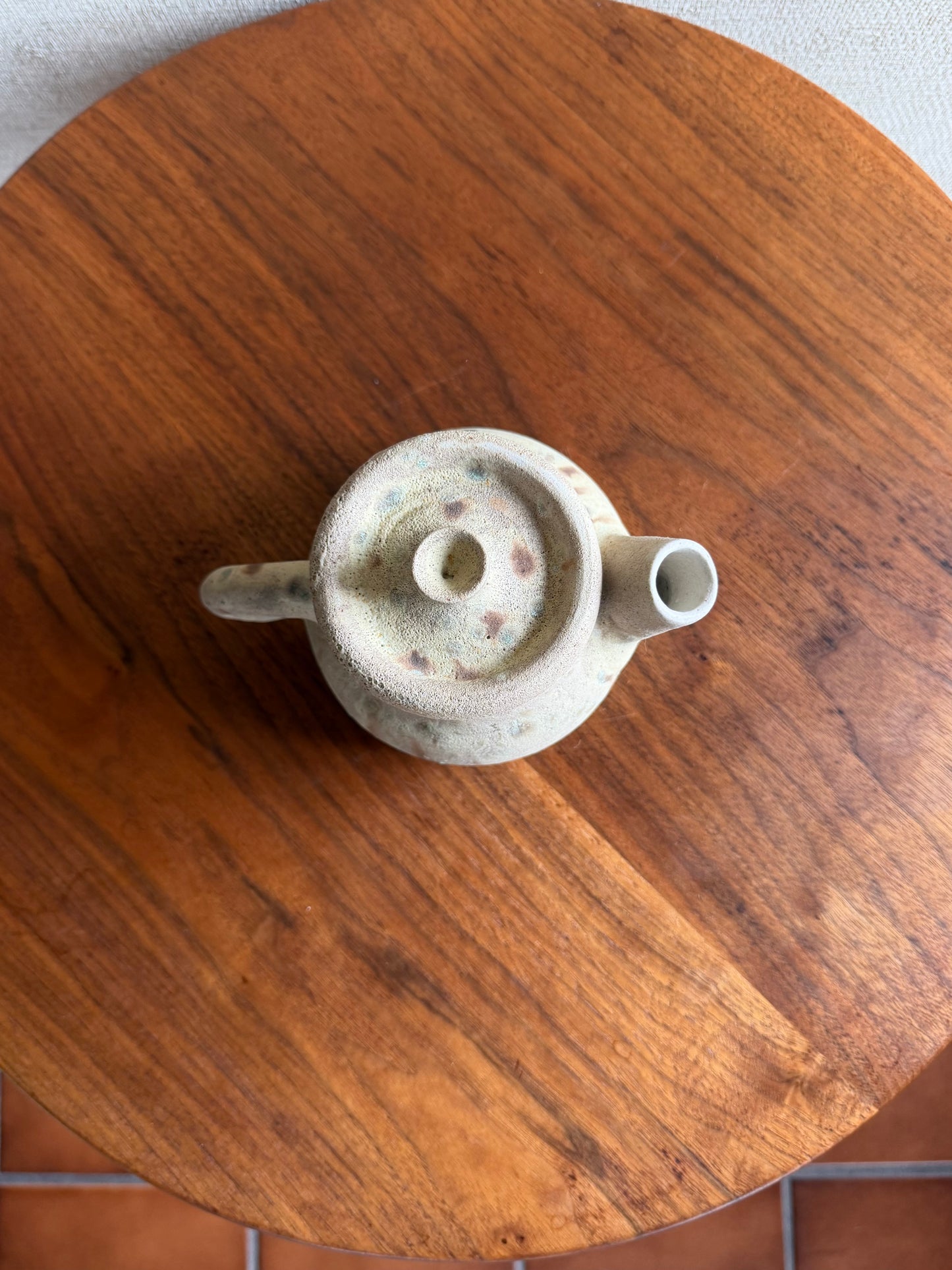 Ceramic teapot on a wooden surface