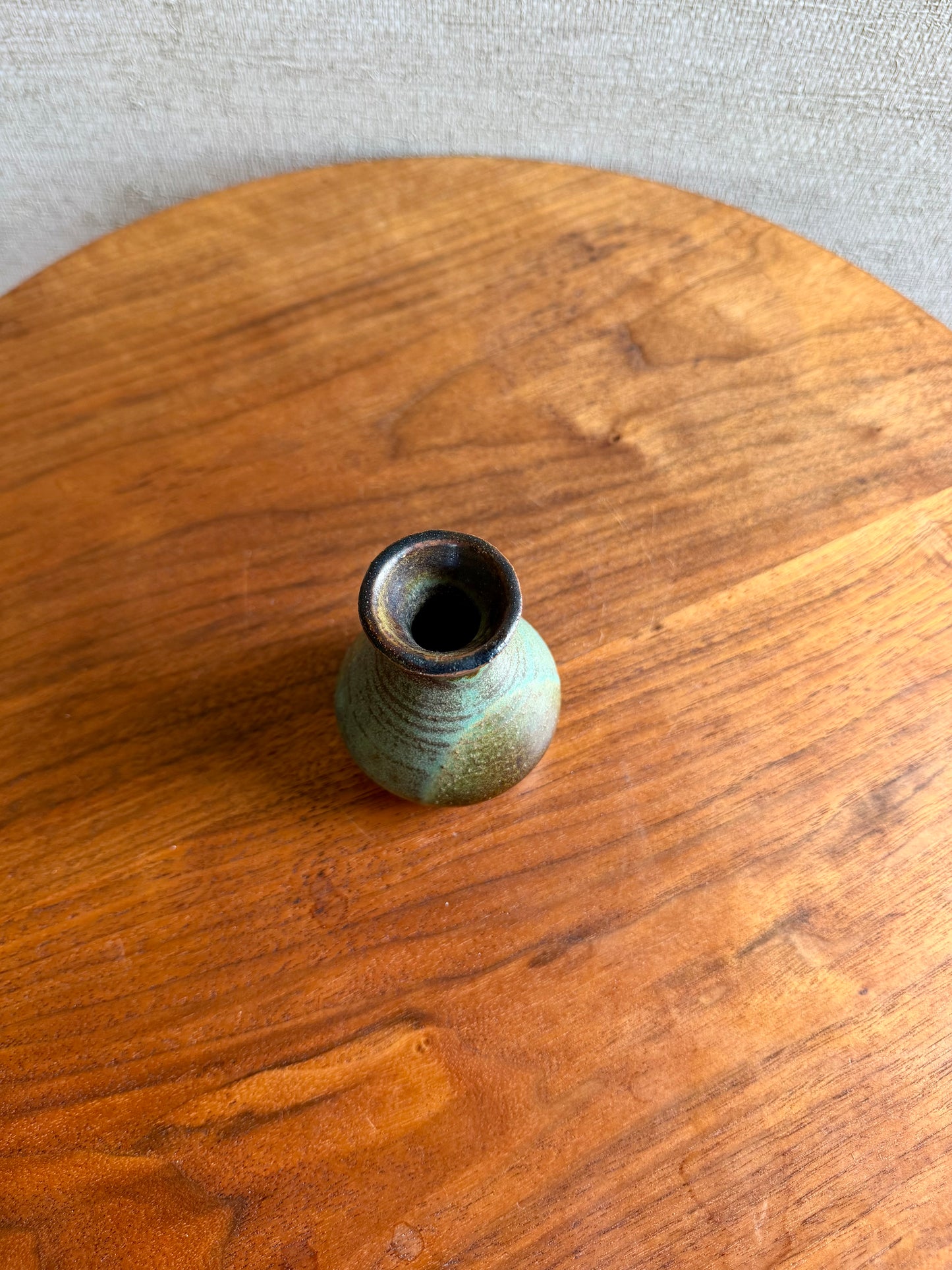 Small ceramic vase on a wooden surface