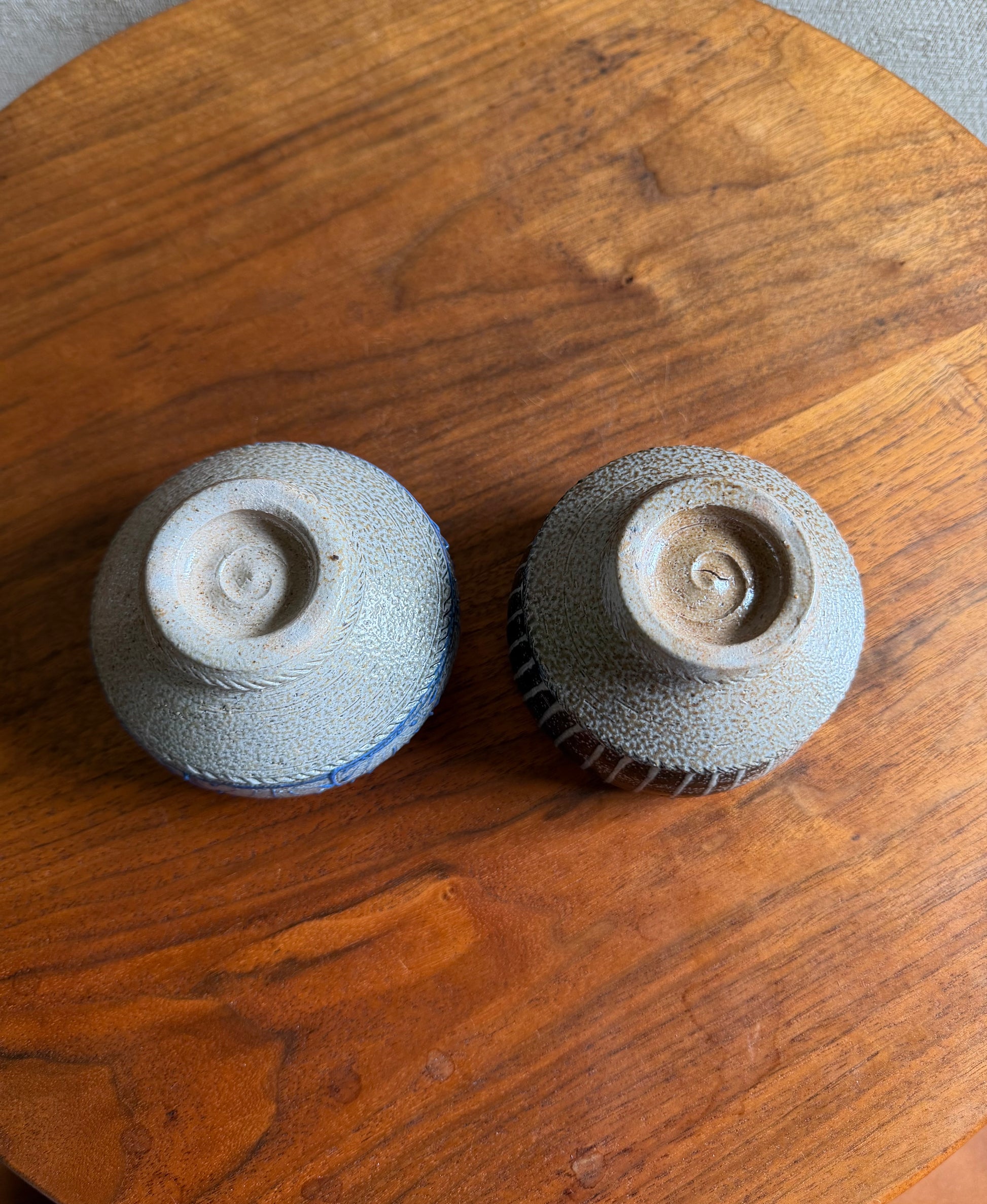 Two ceramic items on a wooden surface