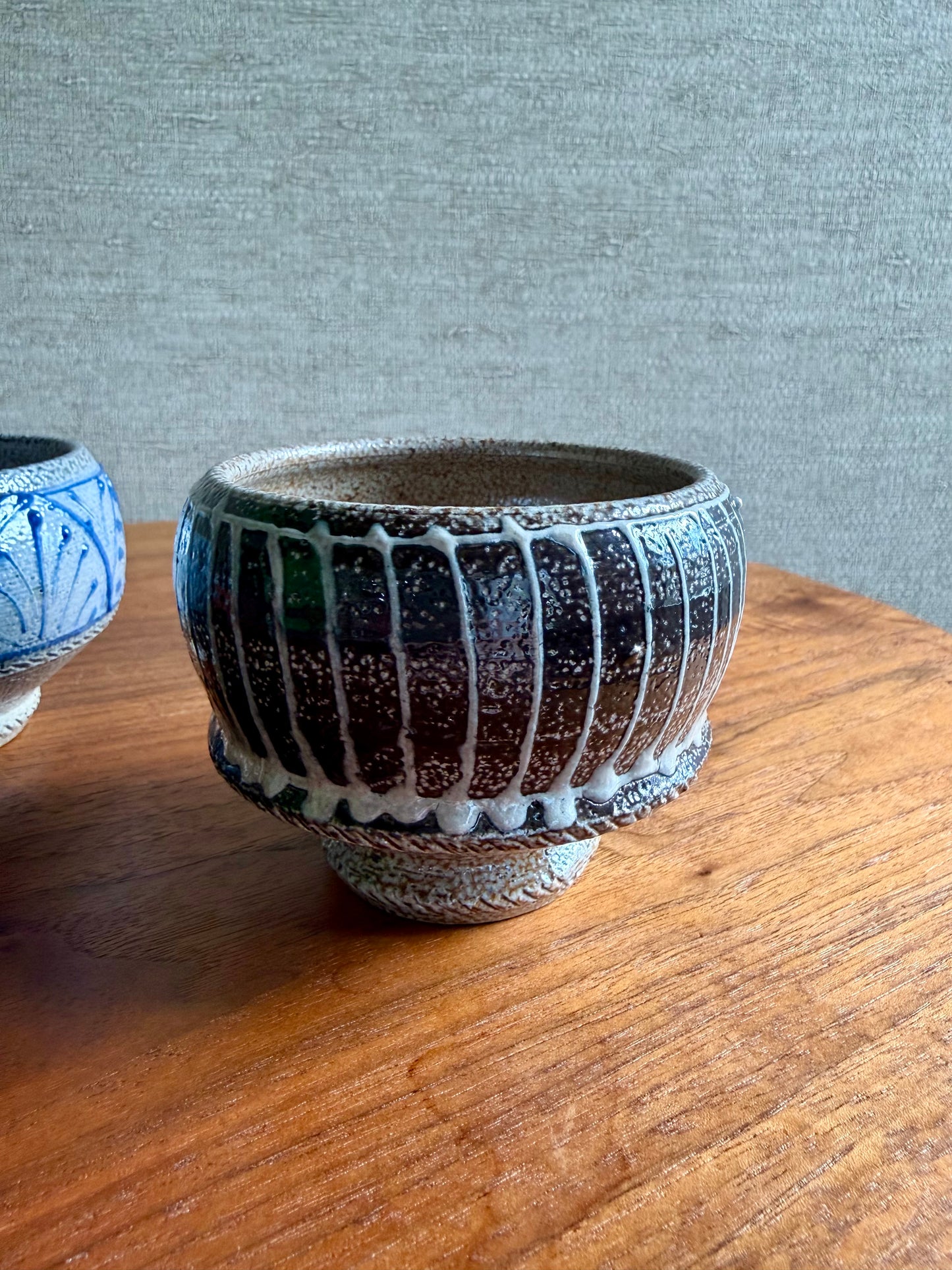 Ceramic pot with textured design on a wooden surface