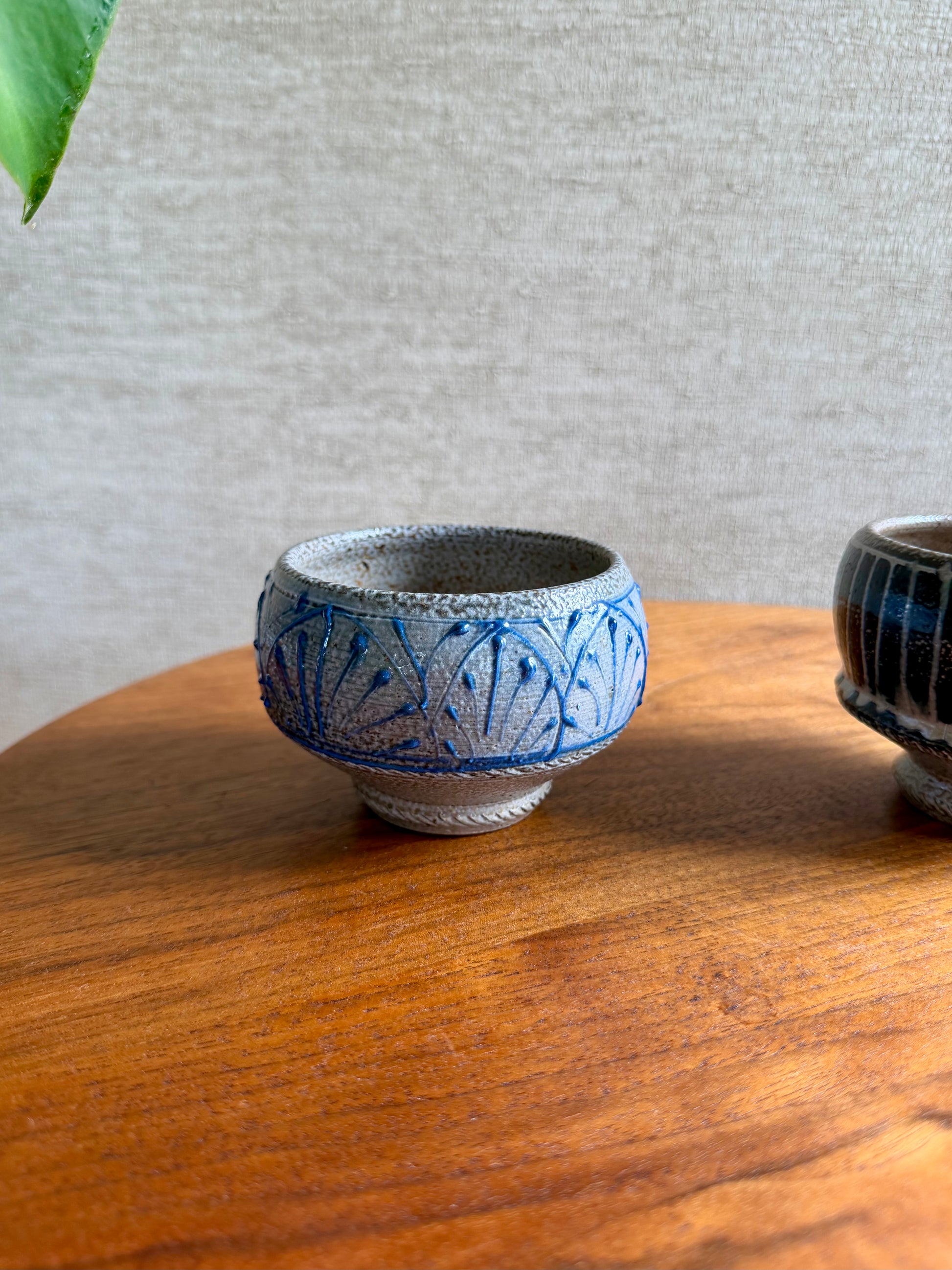 Ceramic bowl with blue patterns on a wooden surface