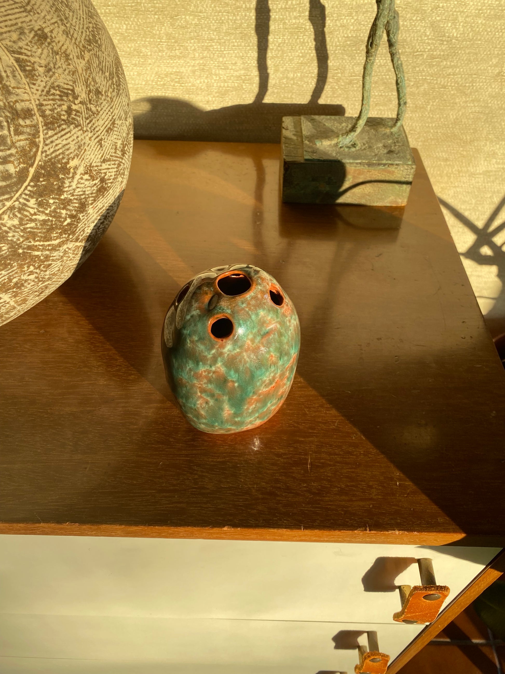 Vintage ceramic pottery with a wooden cabinet and other sports equipment in the background