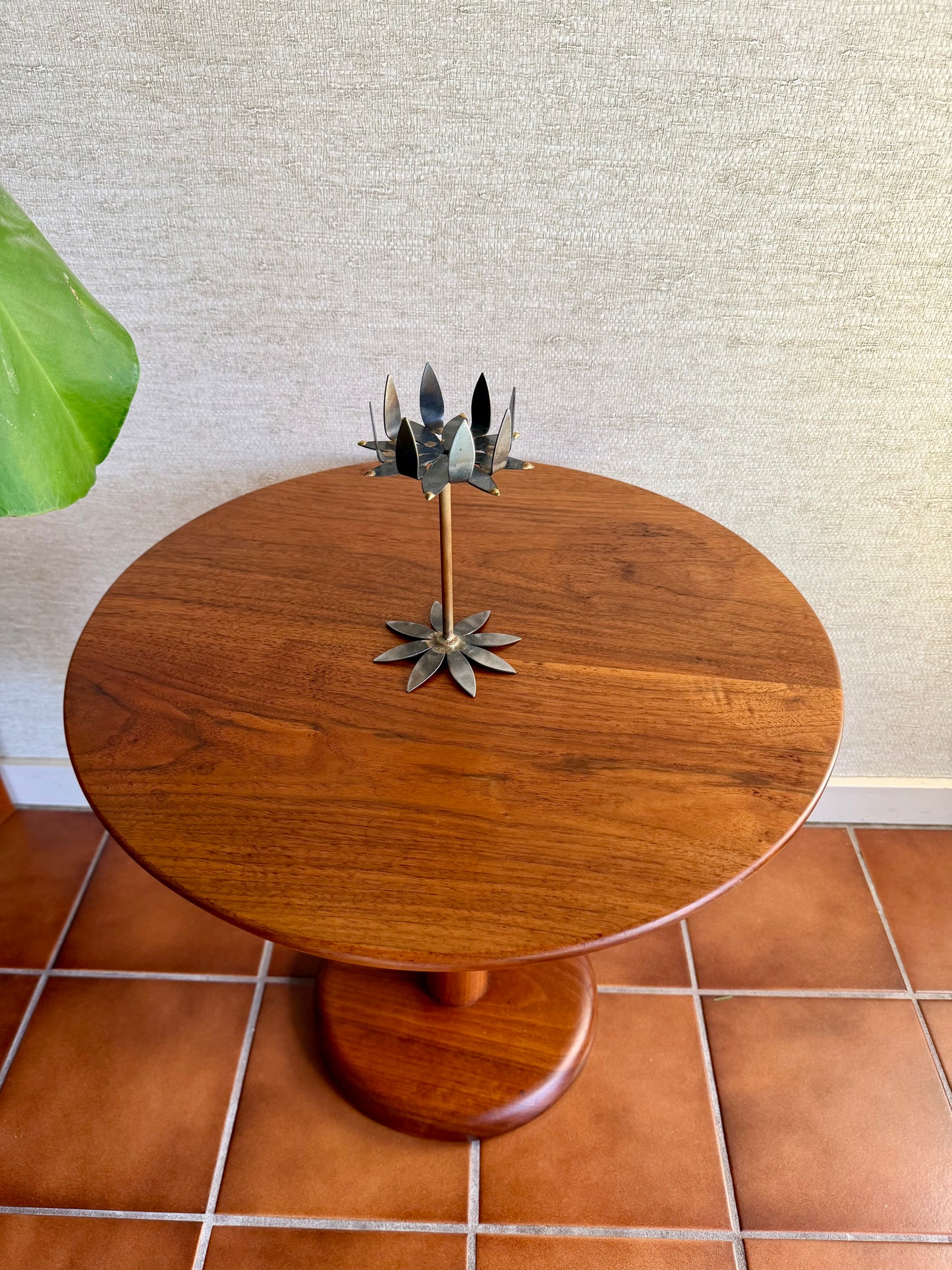 decorative metal nail art candleholder on a wood table
