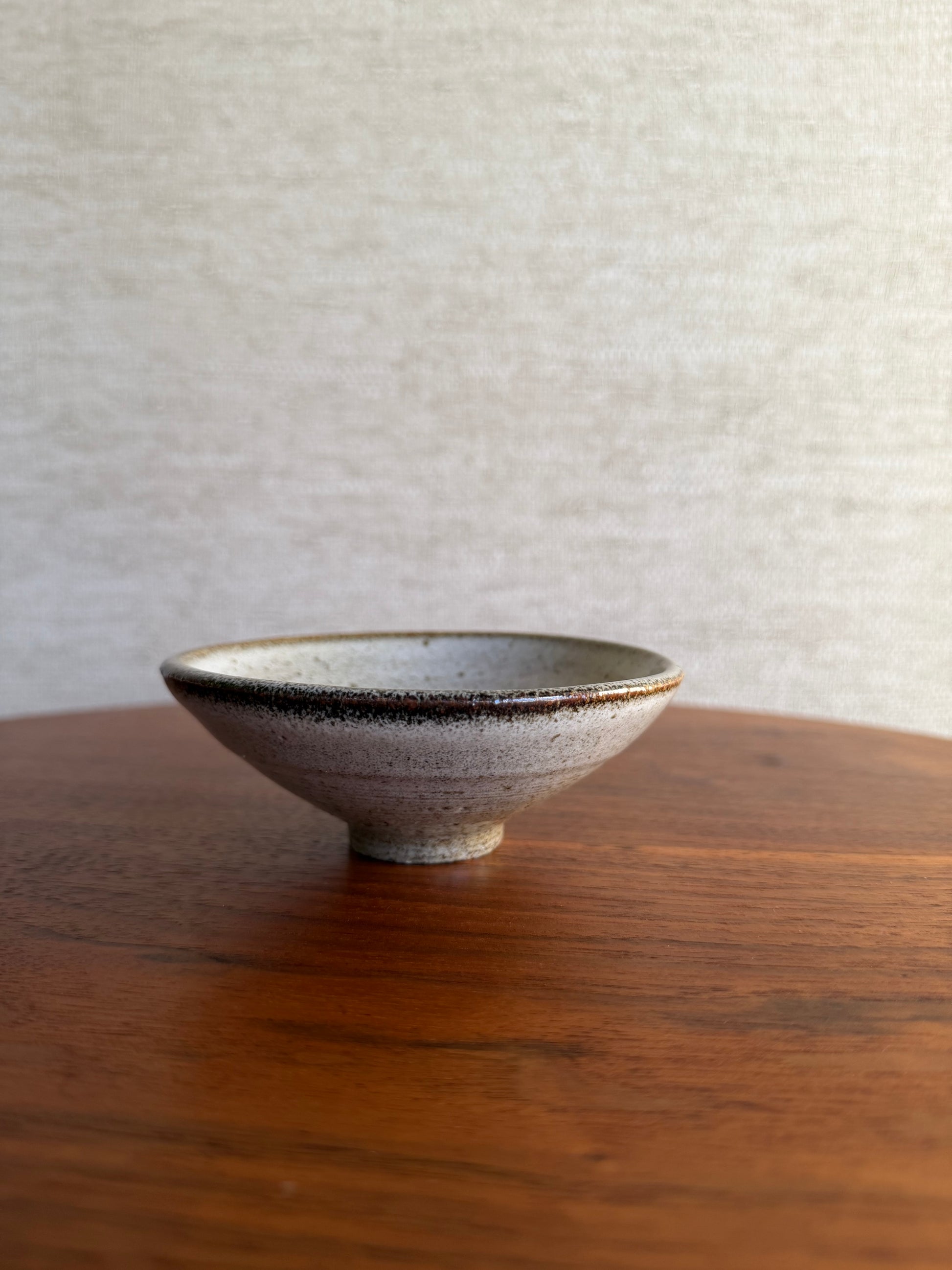 white vintage ceramic pottery bowl on wood table 