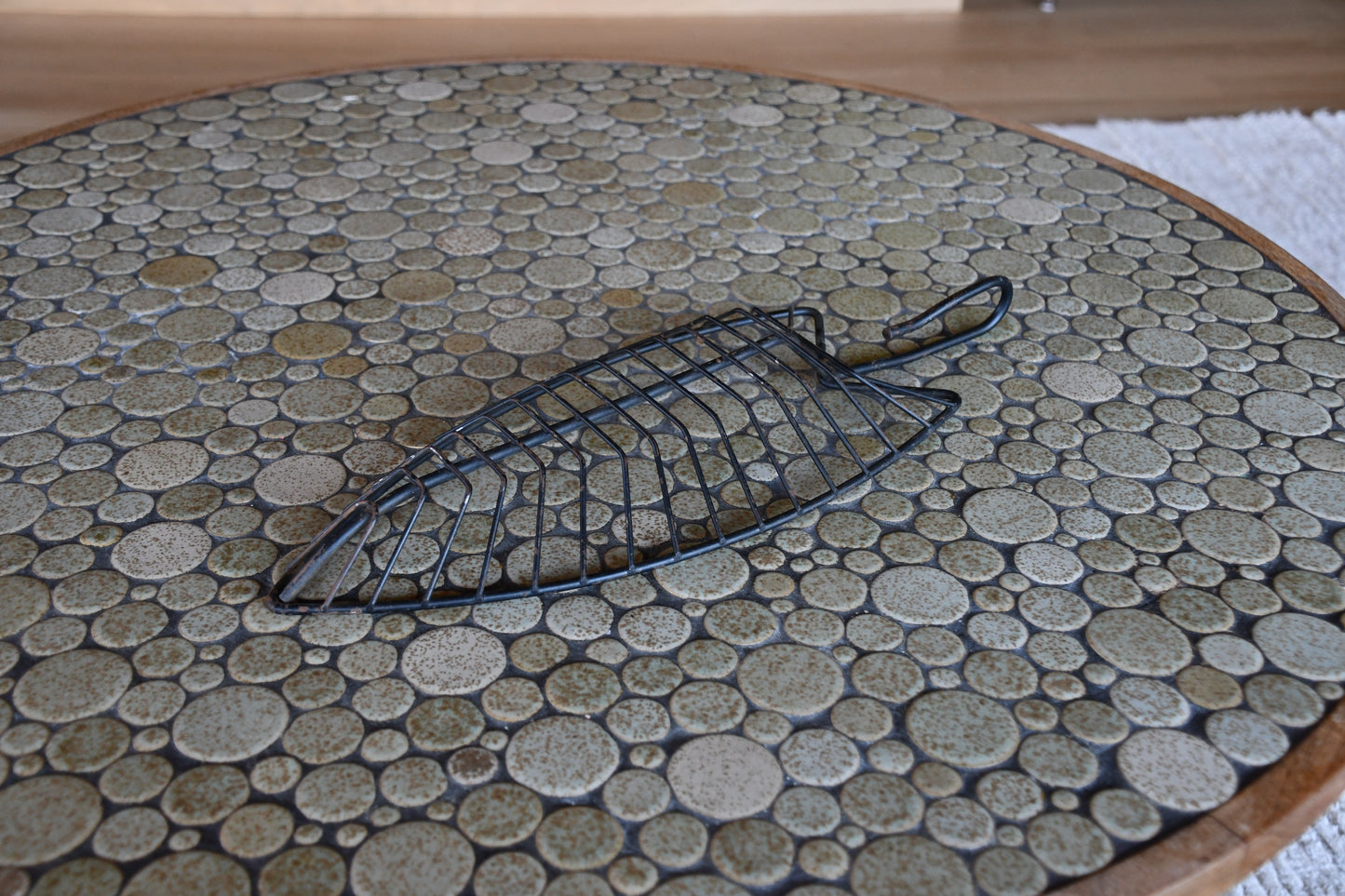 Decorative leaf-shaped metal tray on a stone-patterned surface