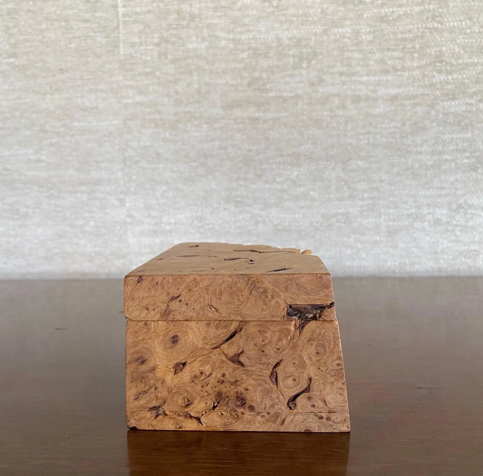 Wooden box with a textured surface on a neutral background