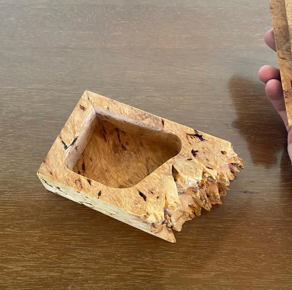 Wooden box with a textured surface on a wooden table