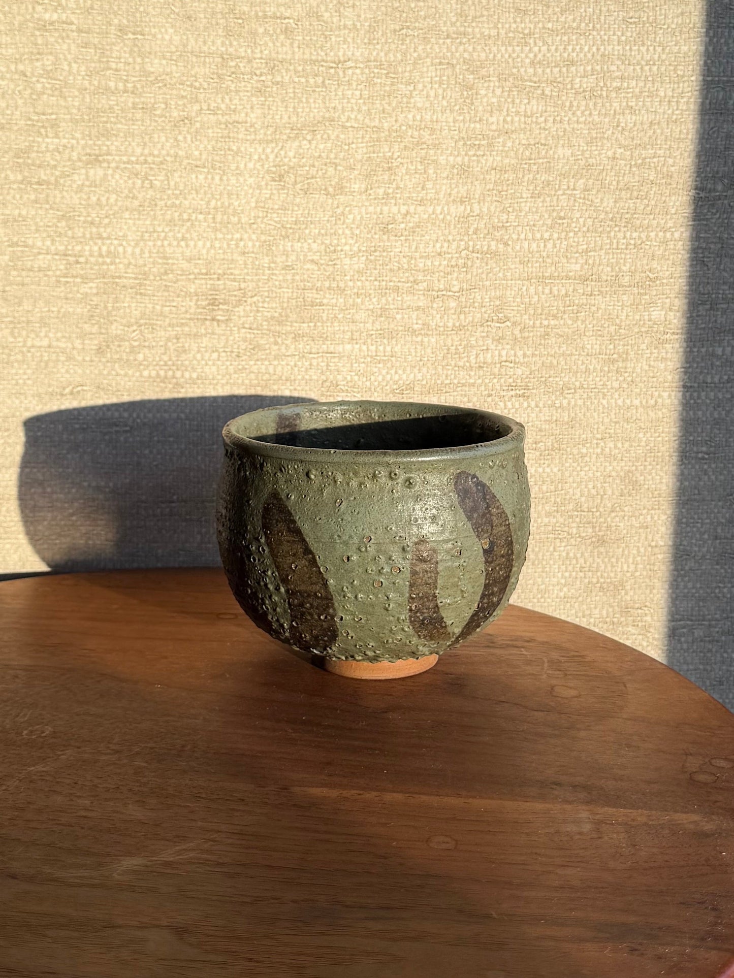 Green Pottery Bowl on wood table 
