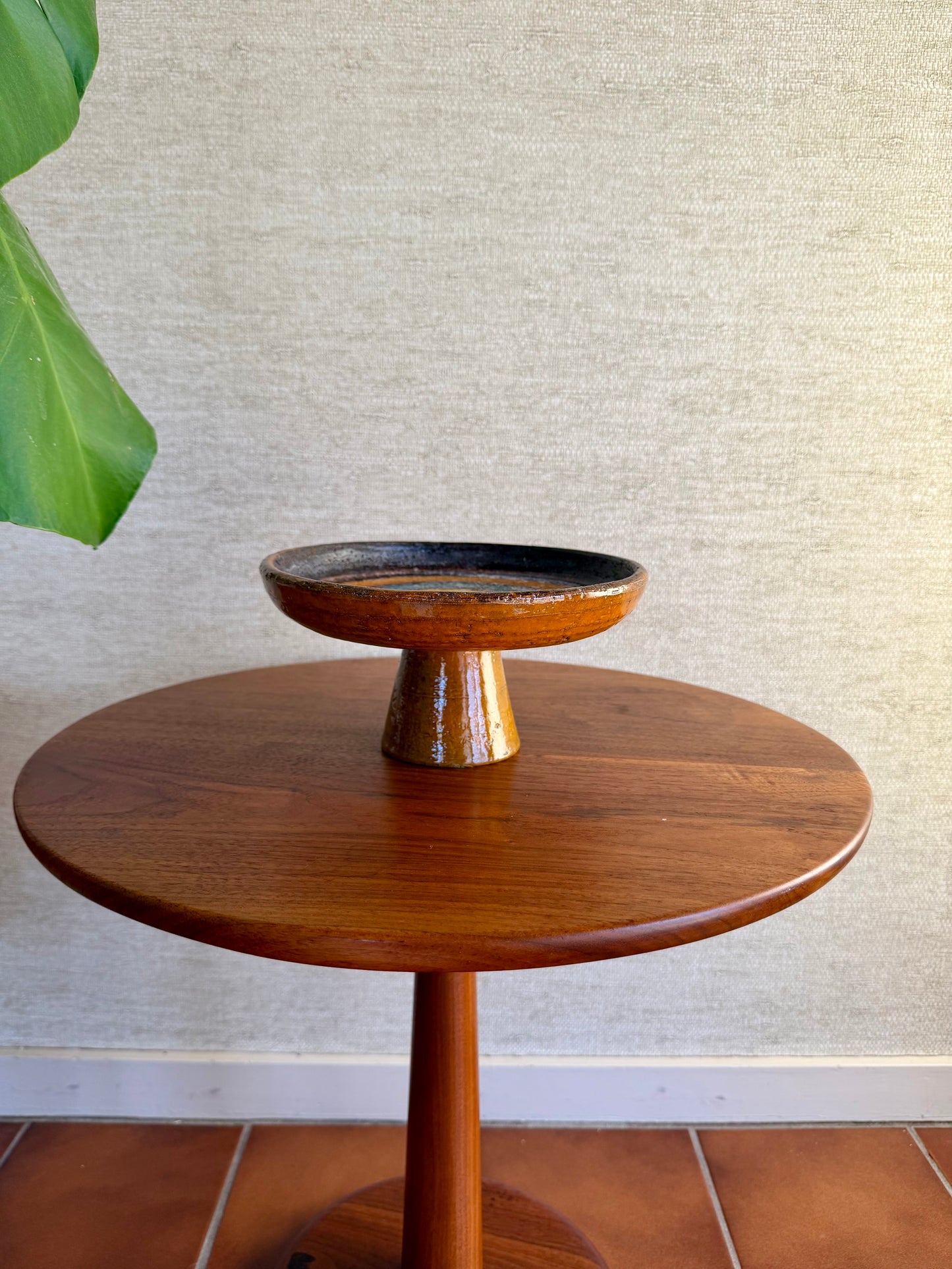 Orange Ceramic Pottery compote on wood table 