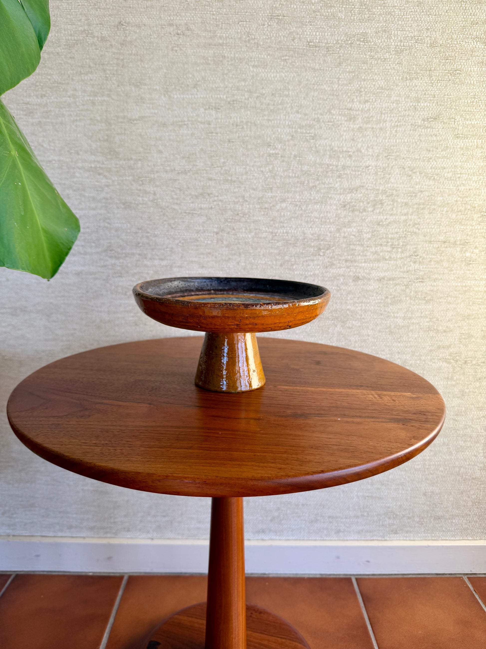 Orange Ceramic Pottery compote on wood table 