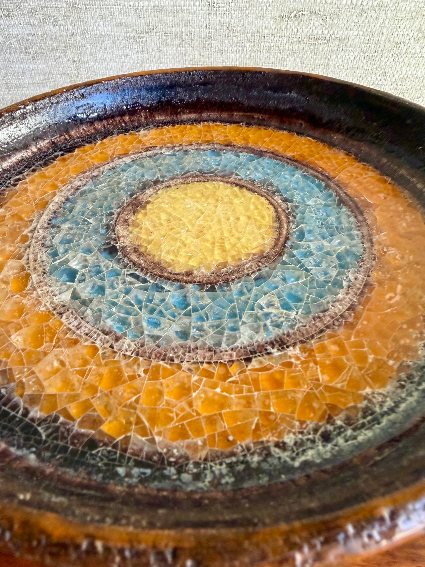 Ceramic compote with a textured, multicolored design on a neutral background