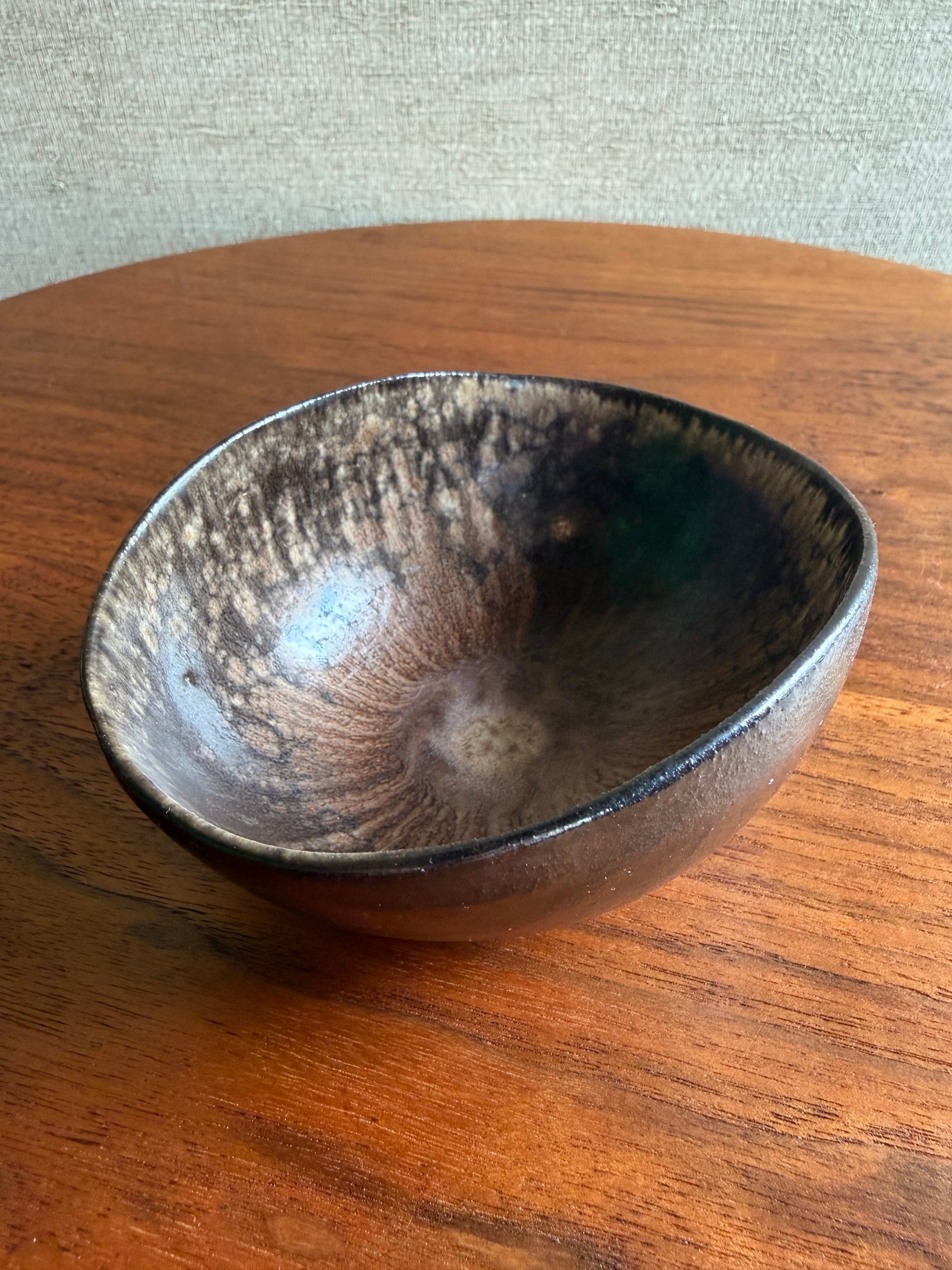 Ceramic bowl with a textured surface on a wooden surface