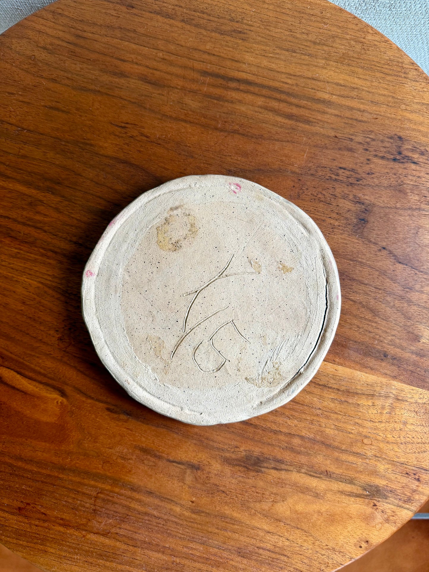 Round ceramic object on a wooden surface