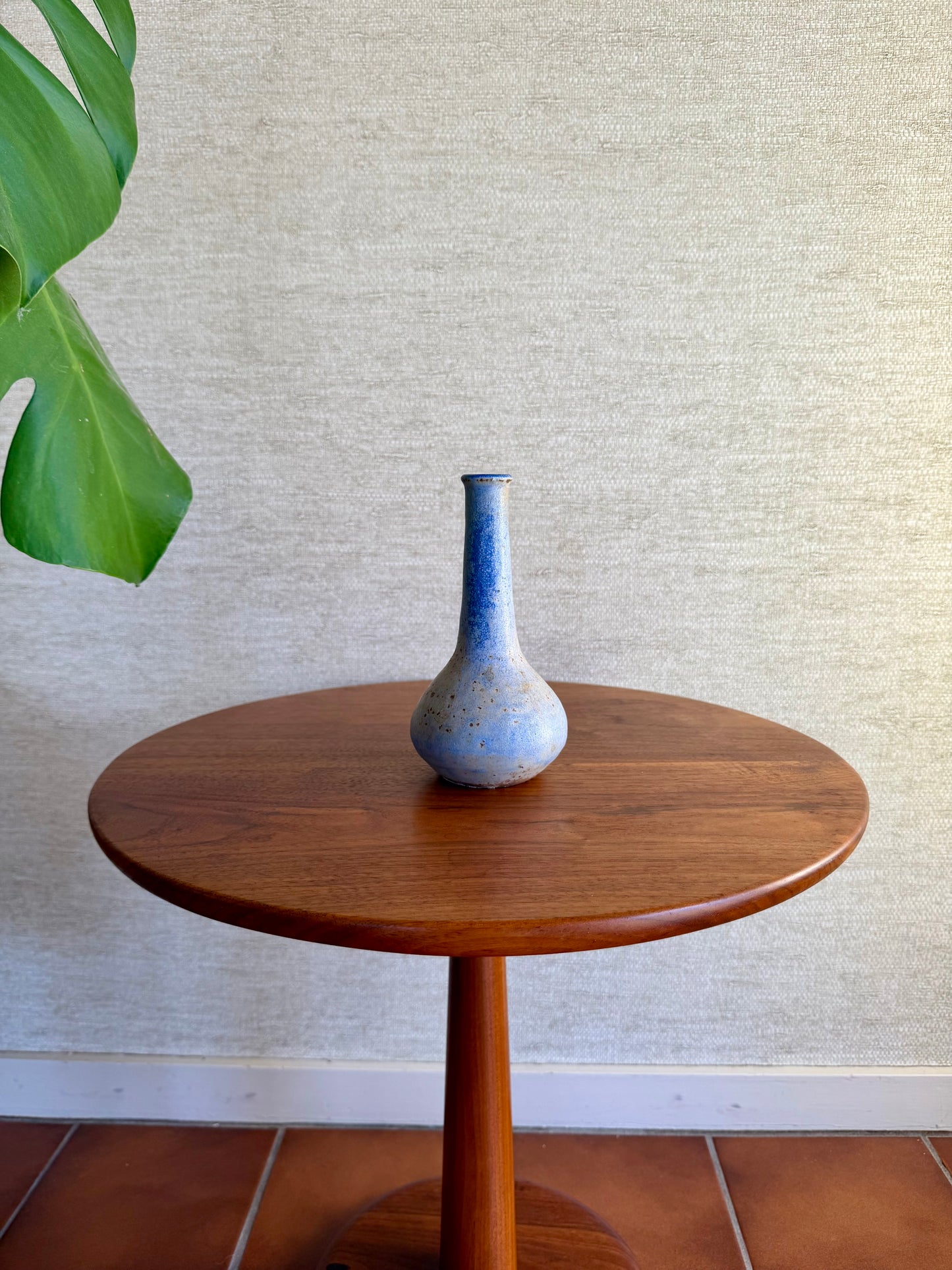 Specked purple vase on wood table