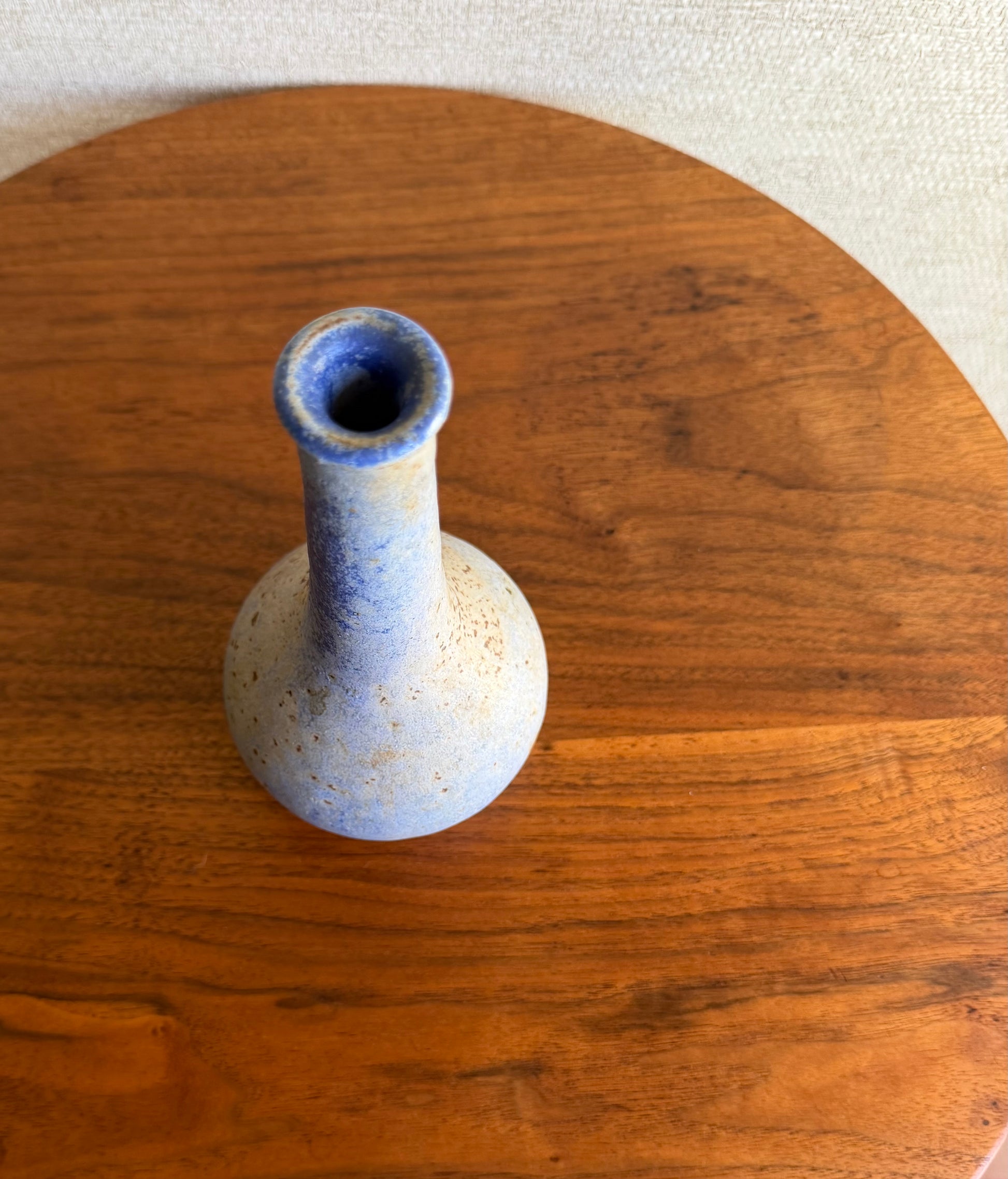 Specked purple vase on wood table