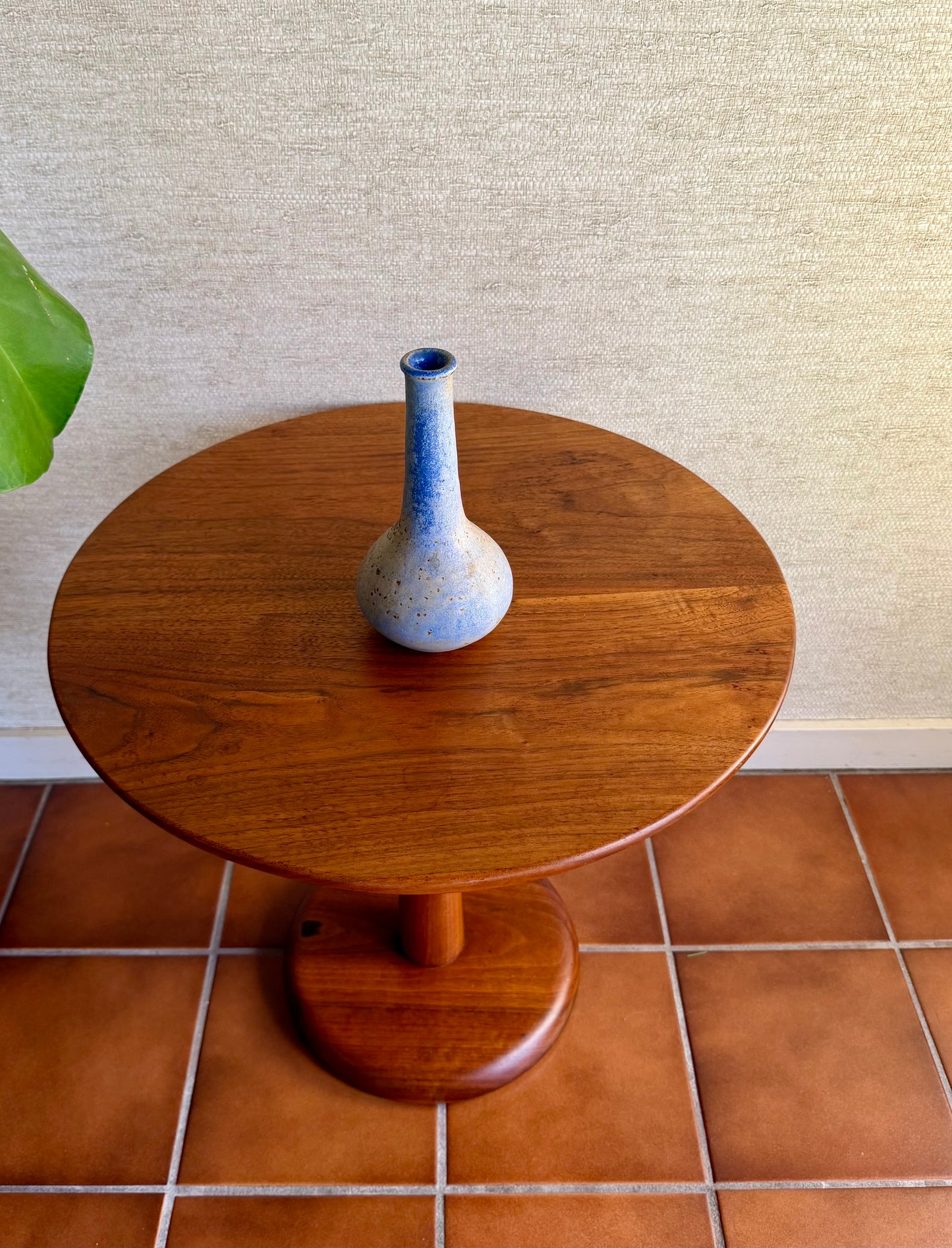 Specked purple vase on wood table