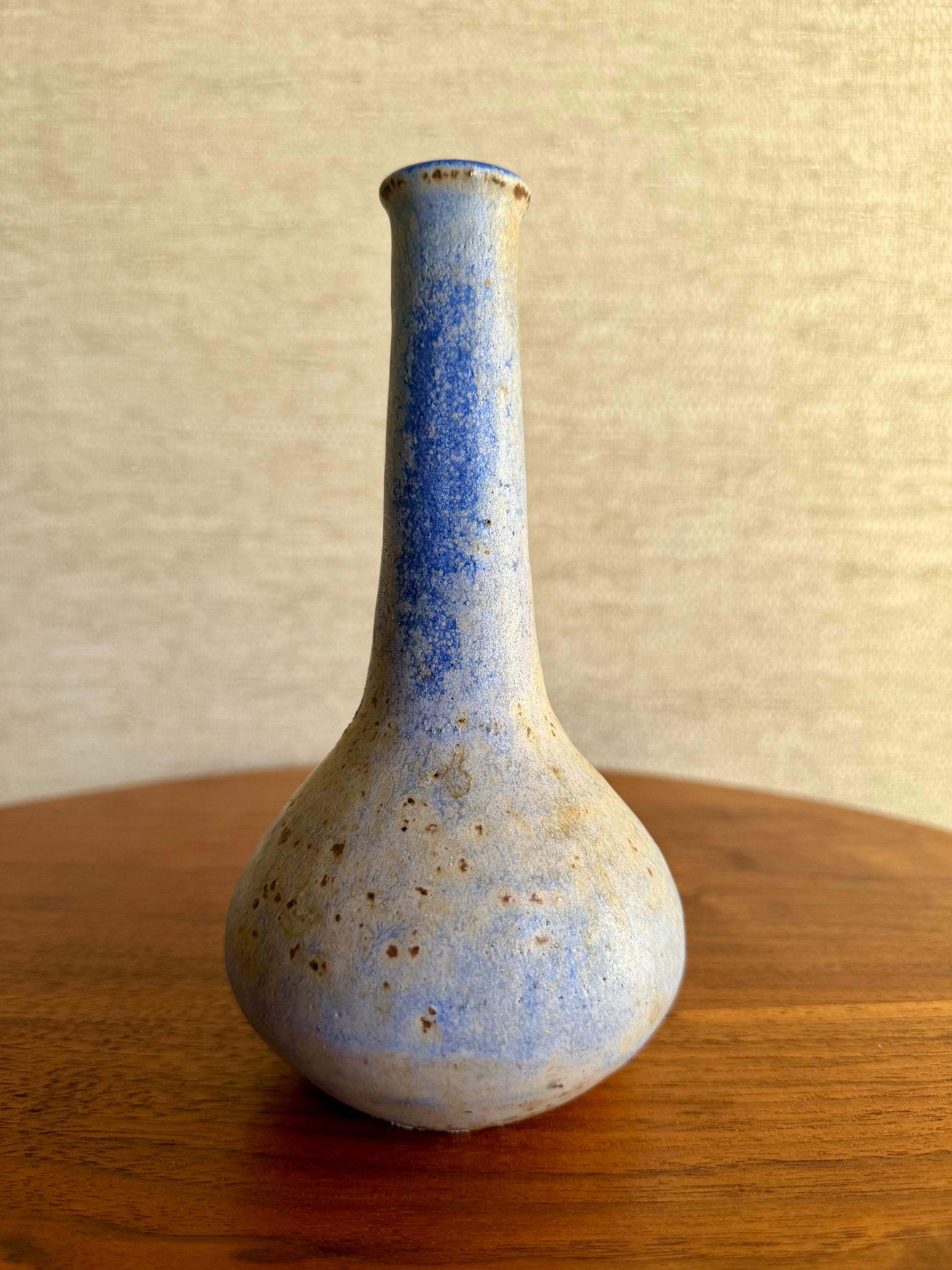 Specked purple vase on wood table
