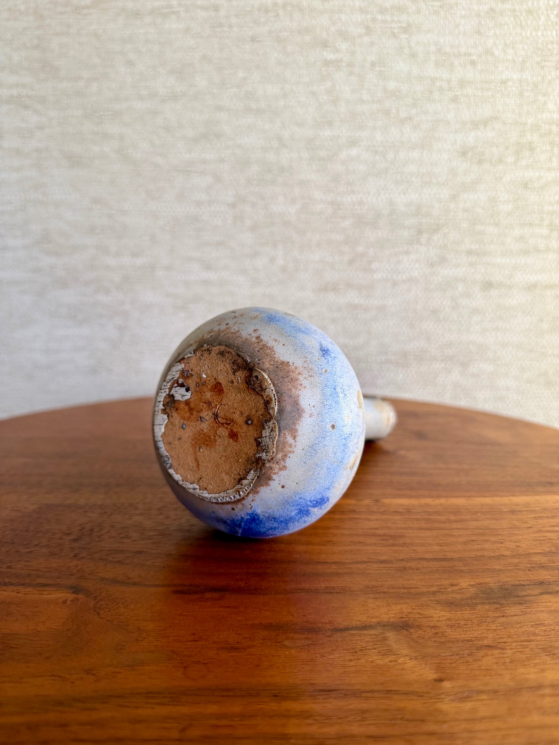 Specked purple vase on wood table