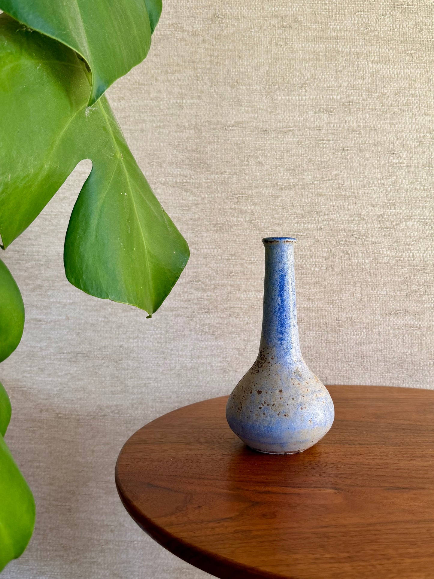 Specked purple vase on wood table