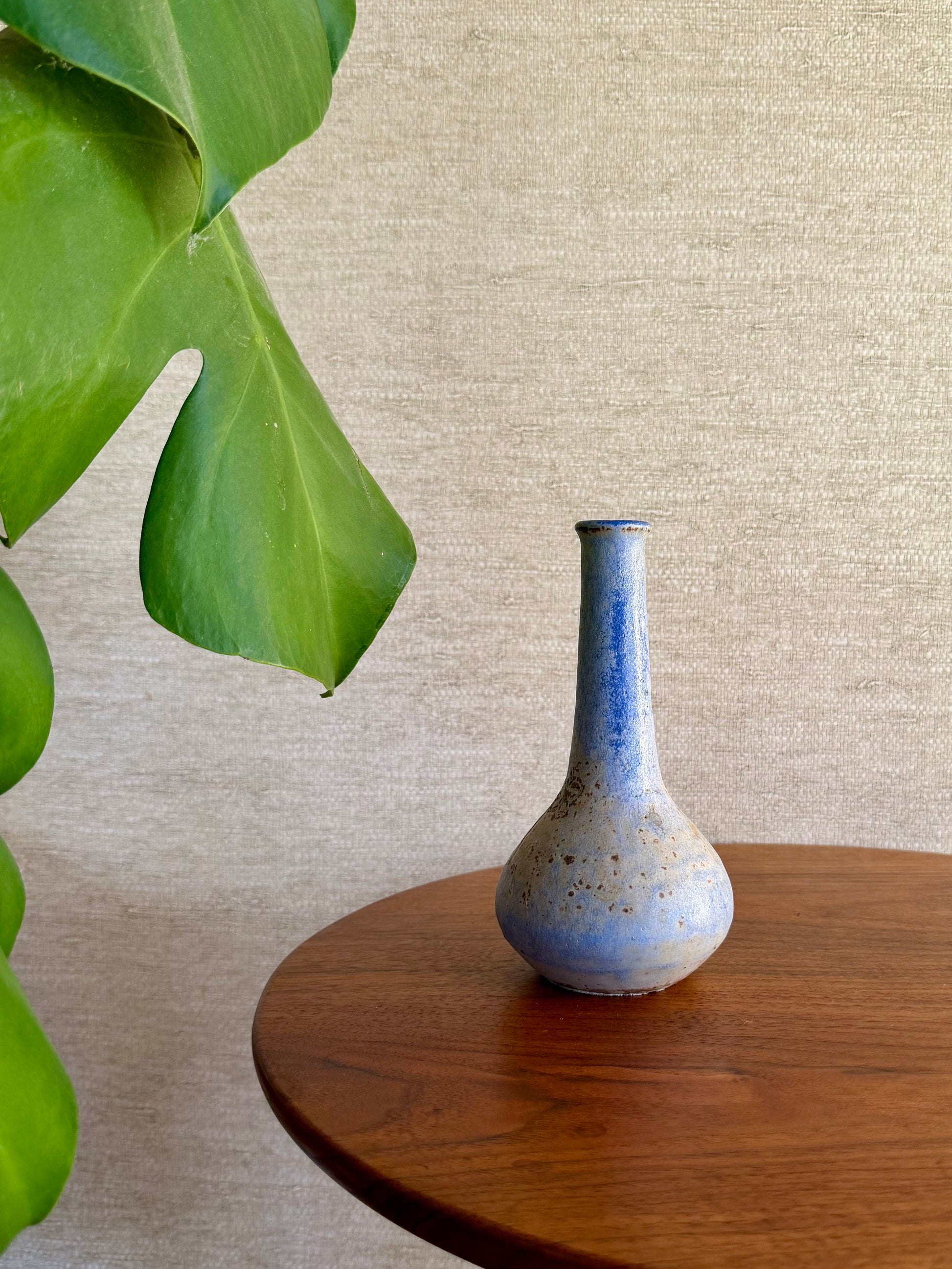 Specked purple vase on wood table